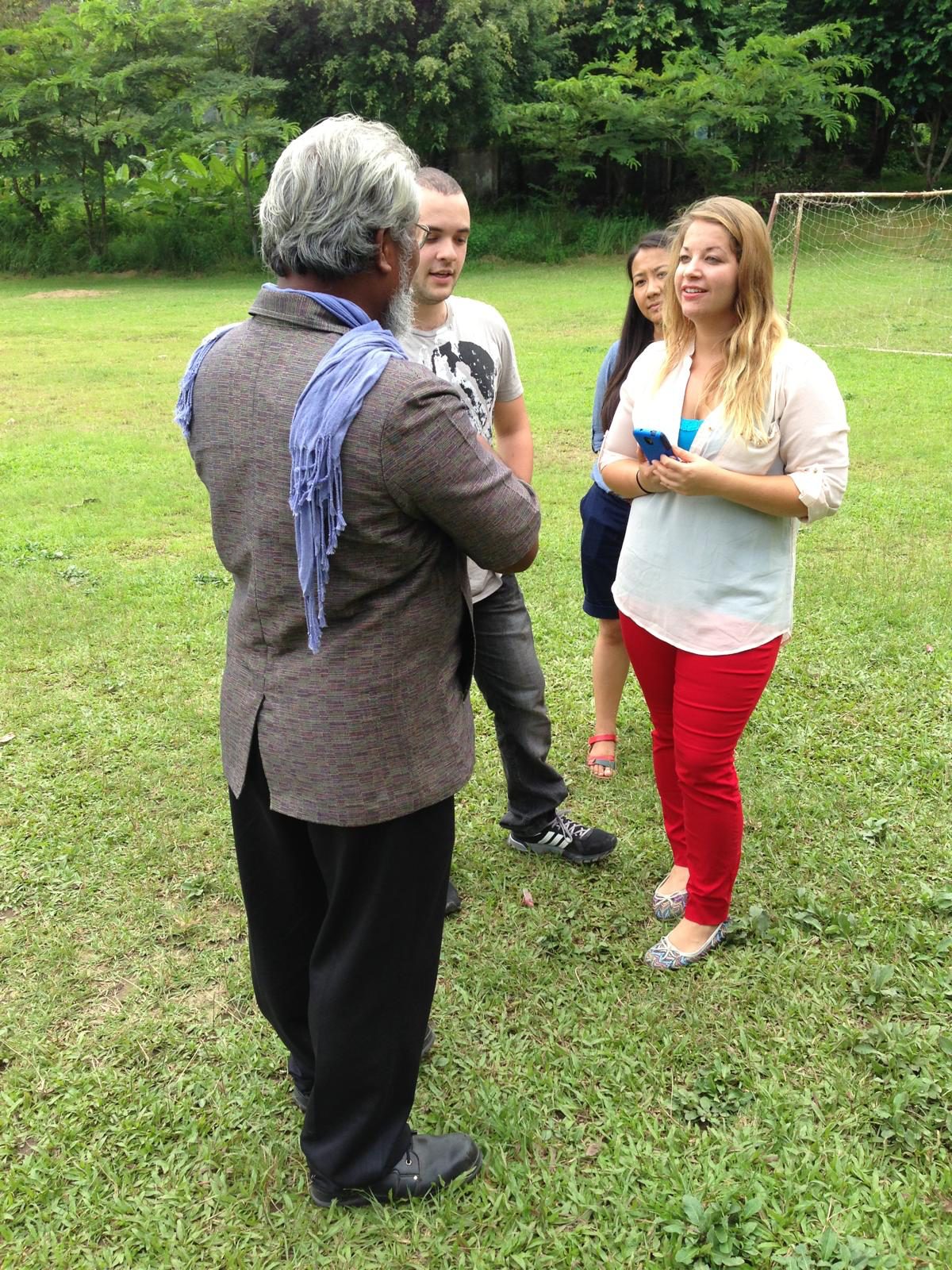 Khun Sompop speaking with PHT participants outdoors in Thailand